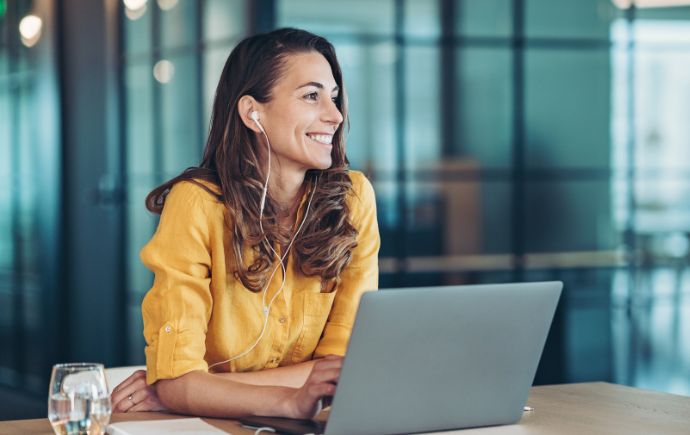 female sitting at desk with computer