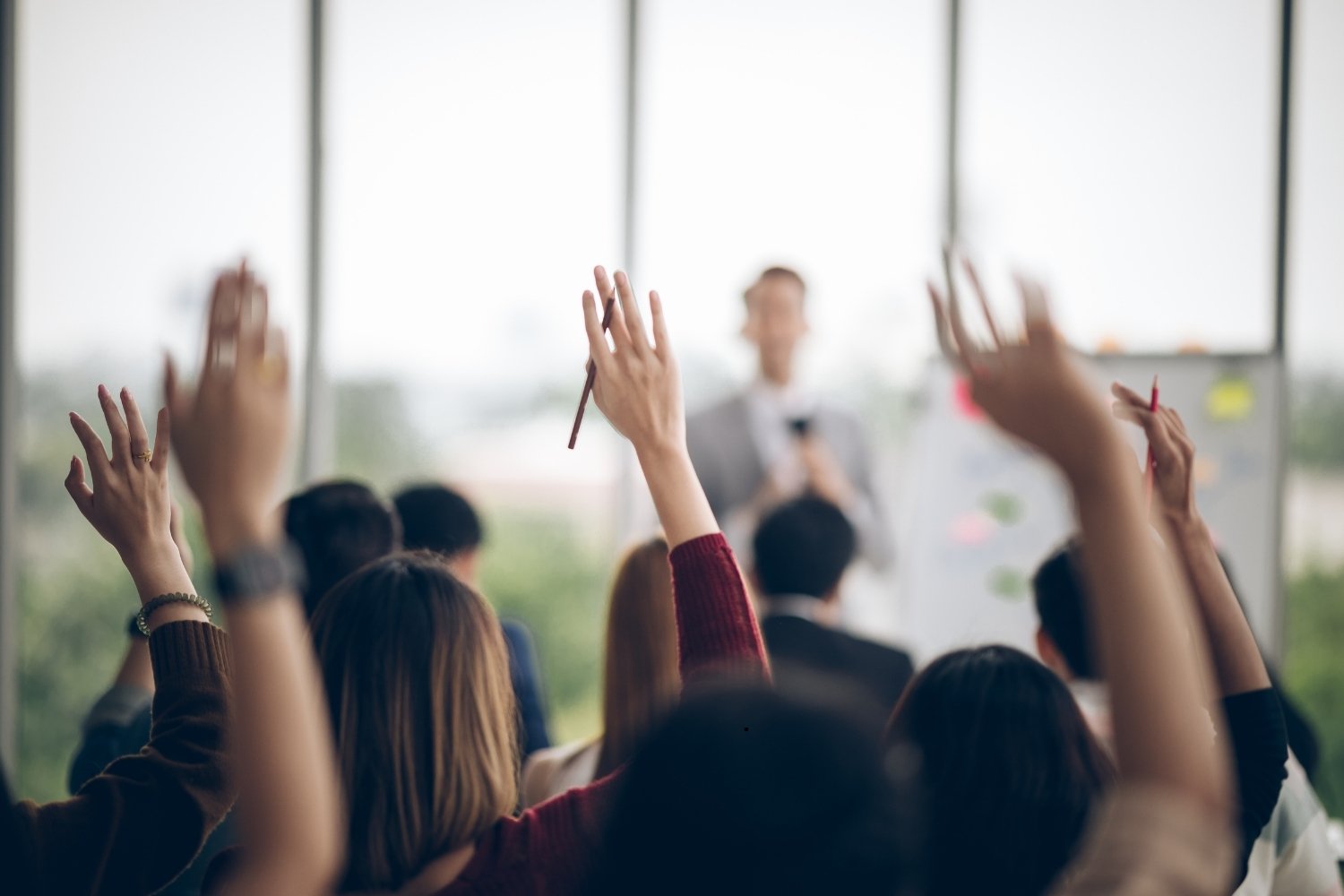 participants-raising-hand-at-seminar