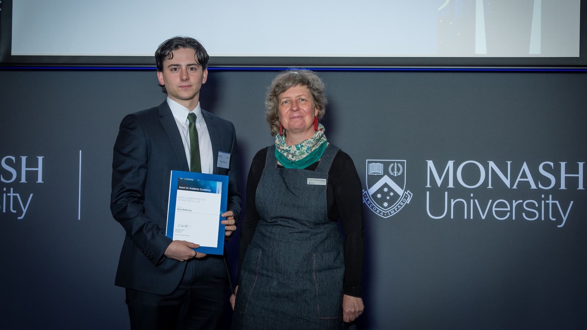 Ethan McNenney accepts his prize from Associate Professor Becky Batagol.