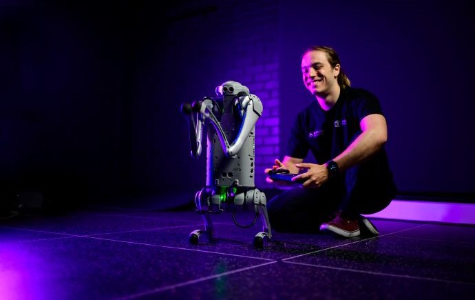 Monash Information Technology student with a robot