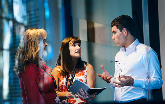 Three professionals discuss strategy