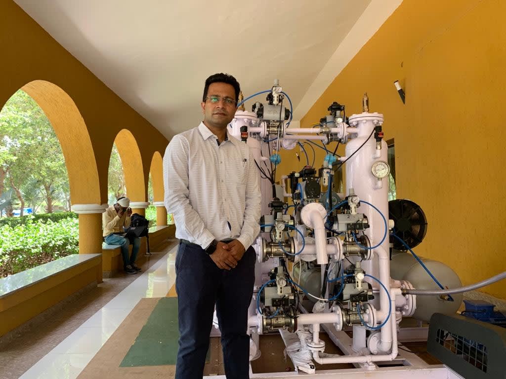 Abhishek Sharma standing in front of his oxygen conversion unit
