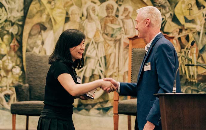Dr Xin (Cindy) Zhang receiving the Mollie Holman Medal from Deputy Dean Professor Paul White