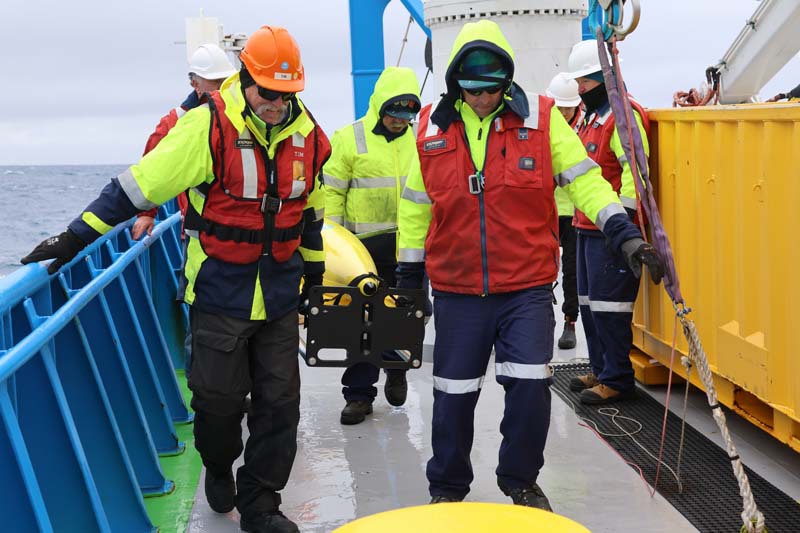 Scientists holding autonomous deep-sea ocean glider