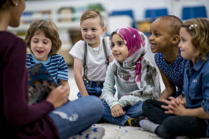 School children sitting on floor