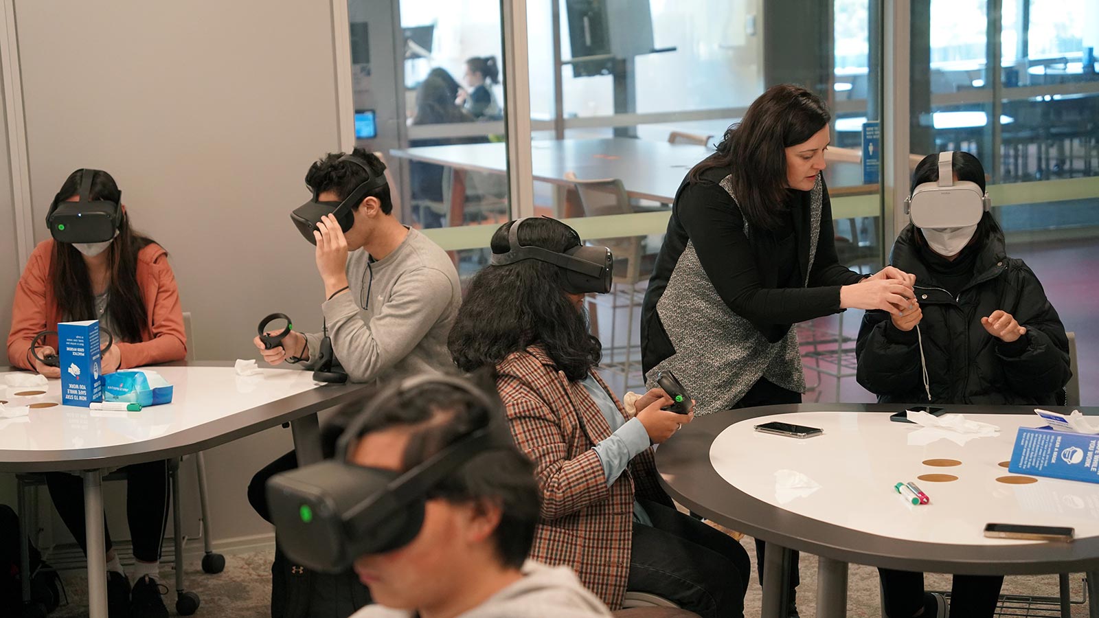 a group of pre-service teachers using VR headsets