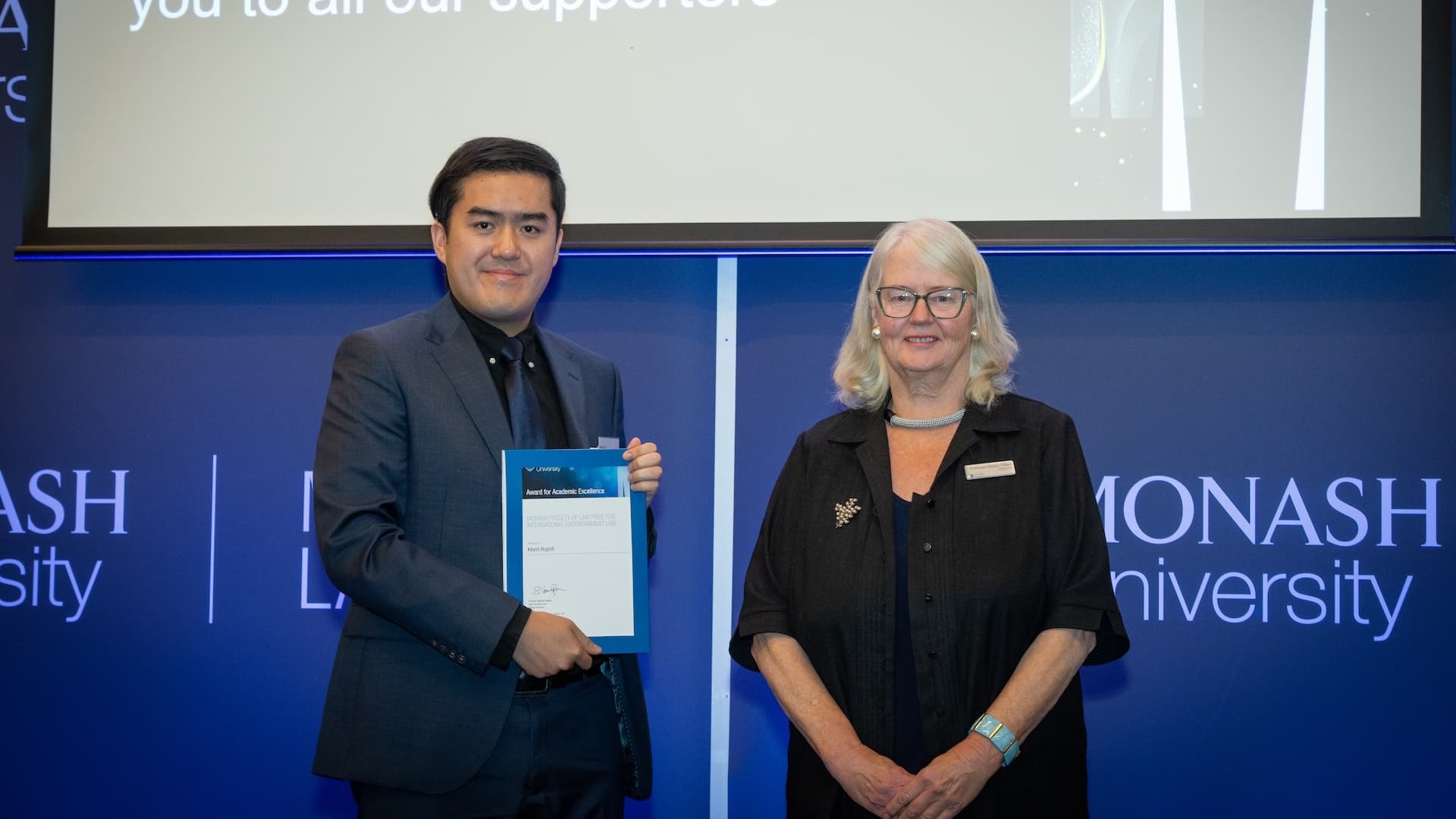Kevin Huynh accepts his prize from Professor Marilyn Pittard.