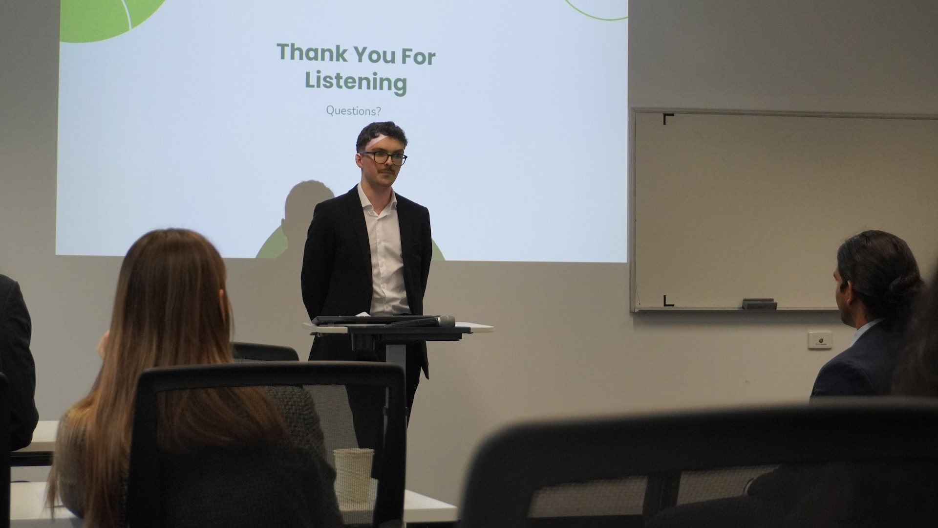 Aiden Morton speaking at a lectern