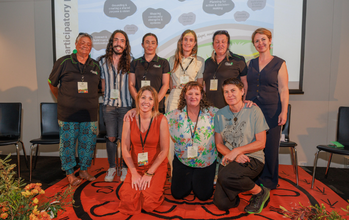Fire to Flourish Community Team Leaders standing on stage at Fire to Flourish National Showcase