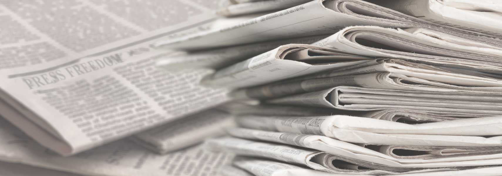 Large pile of rolled-up newspapers