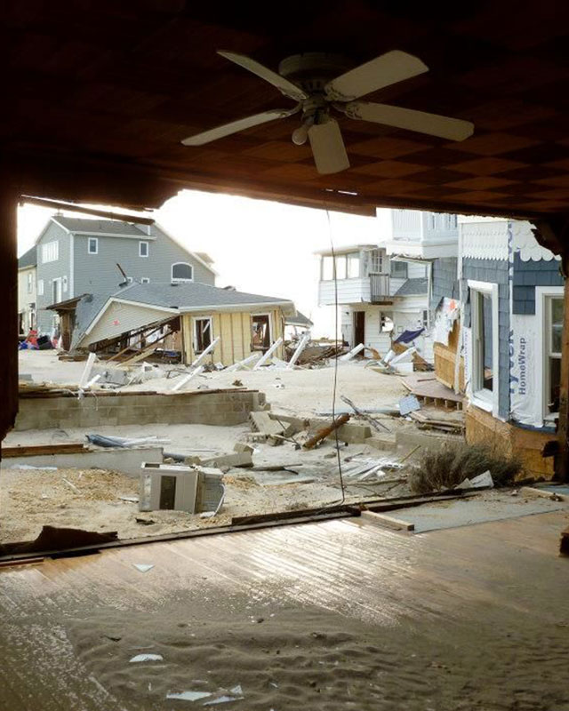 wall removed during hurrican sandy revealing damage neighbours houses