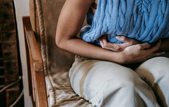 Person holding their stomach in pain