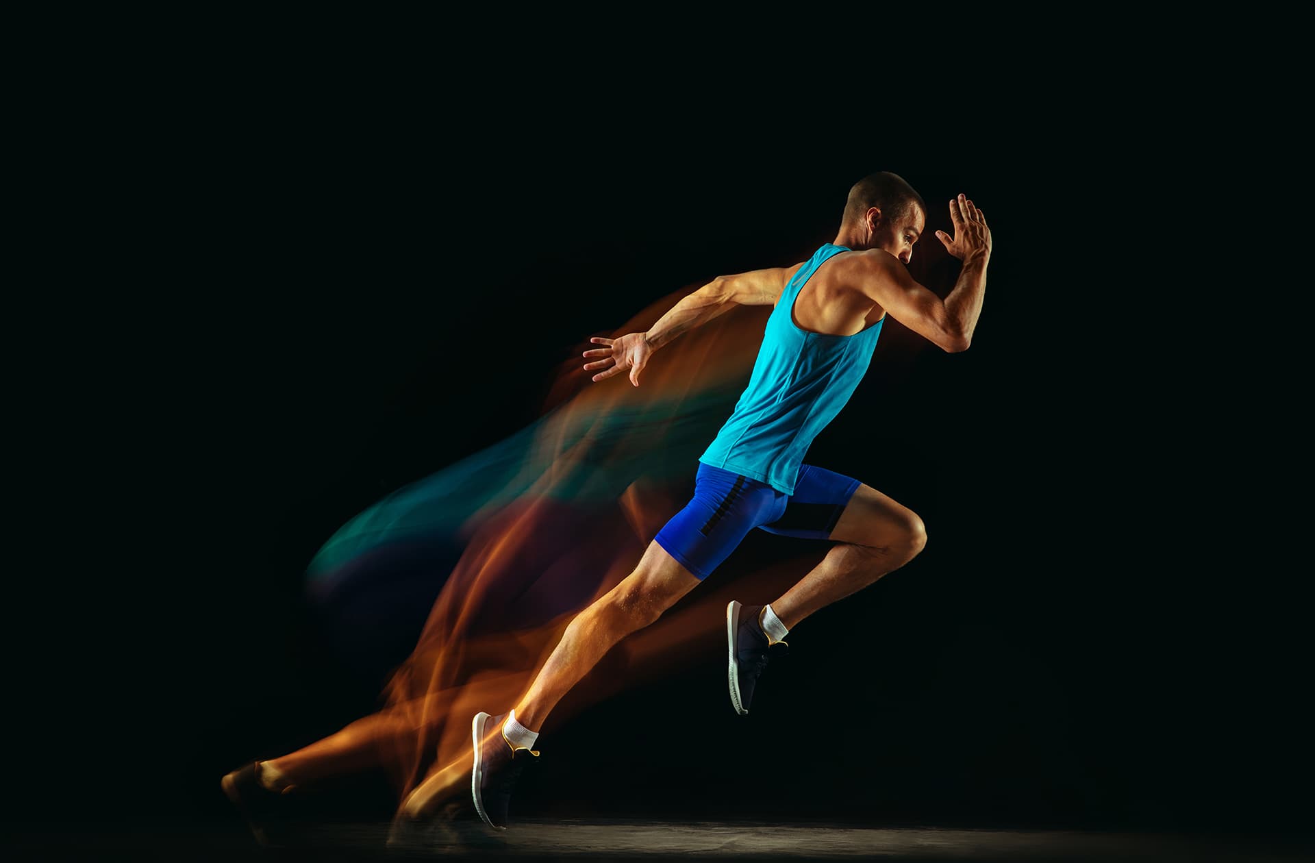 A picture of a young man wearing exercise clothing running with bands of colour corresponding to his skin and clothing trailing behind him.