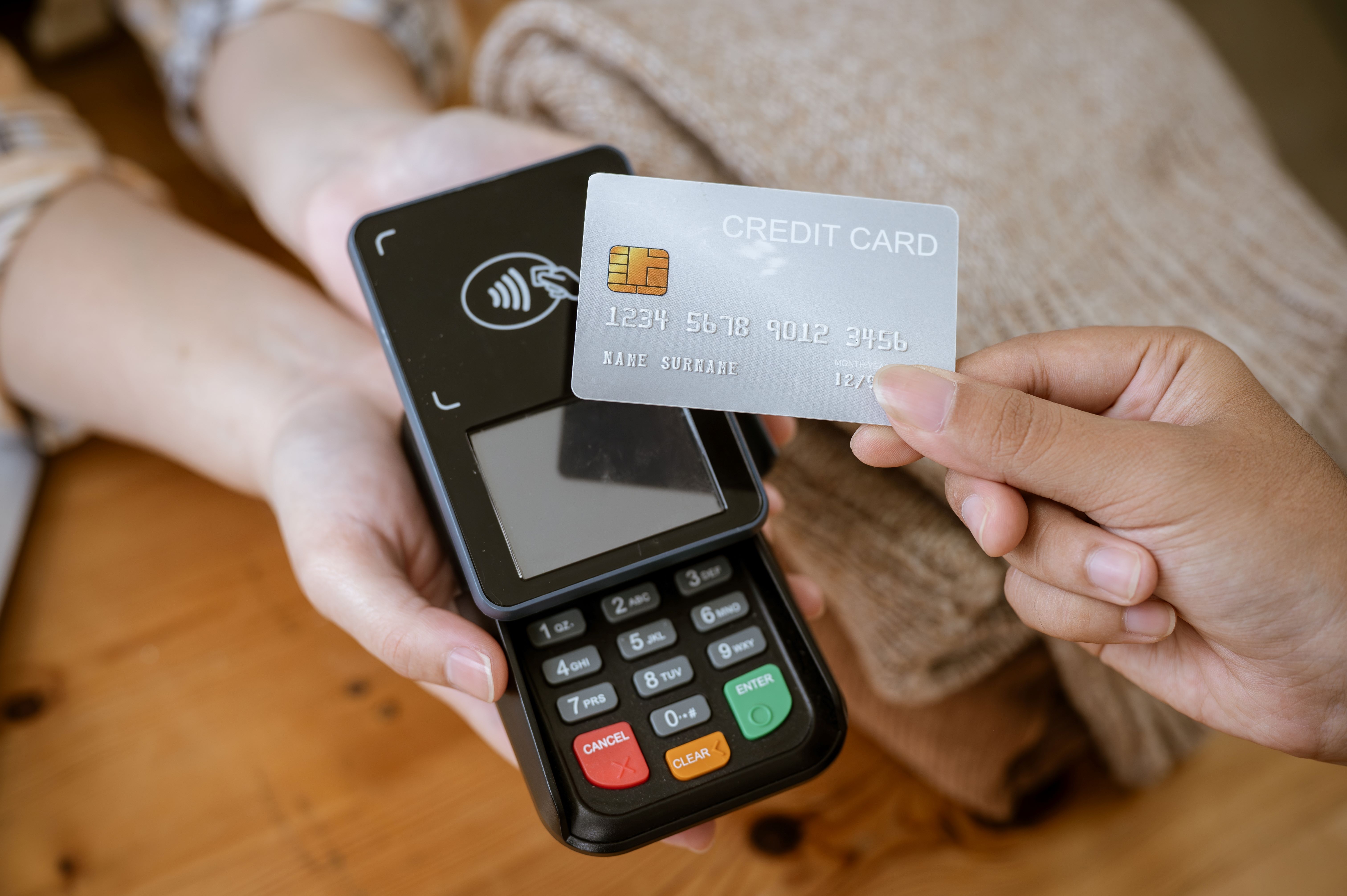 A credit card being tapped agains a payment dock