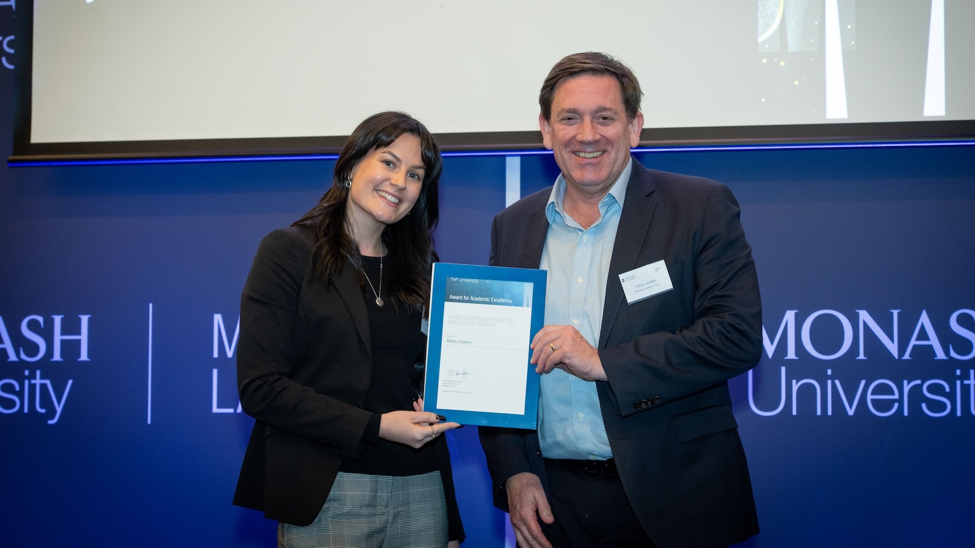 Abbey Crawley accepts her prize from Chris Jordan of Davies Collison Cave.