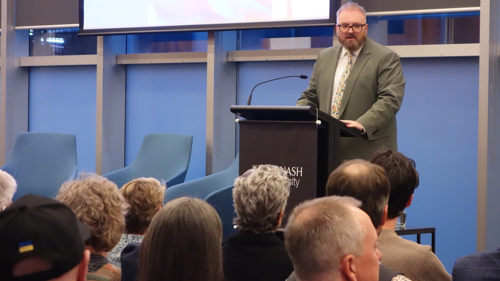 Professor Steven Vaughan standing at a lectern in front of an audience