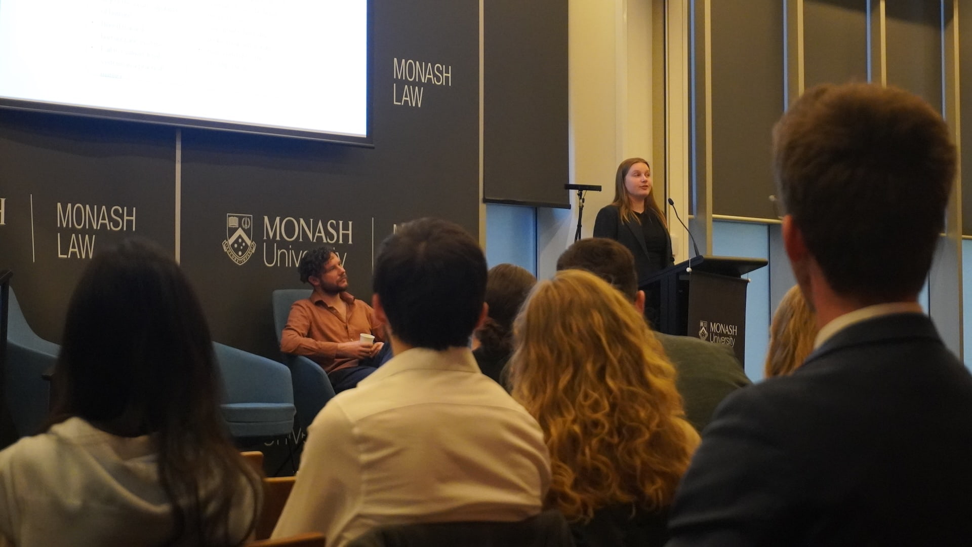 Hannah Bailey speaking at a lectern