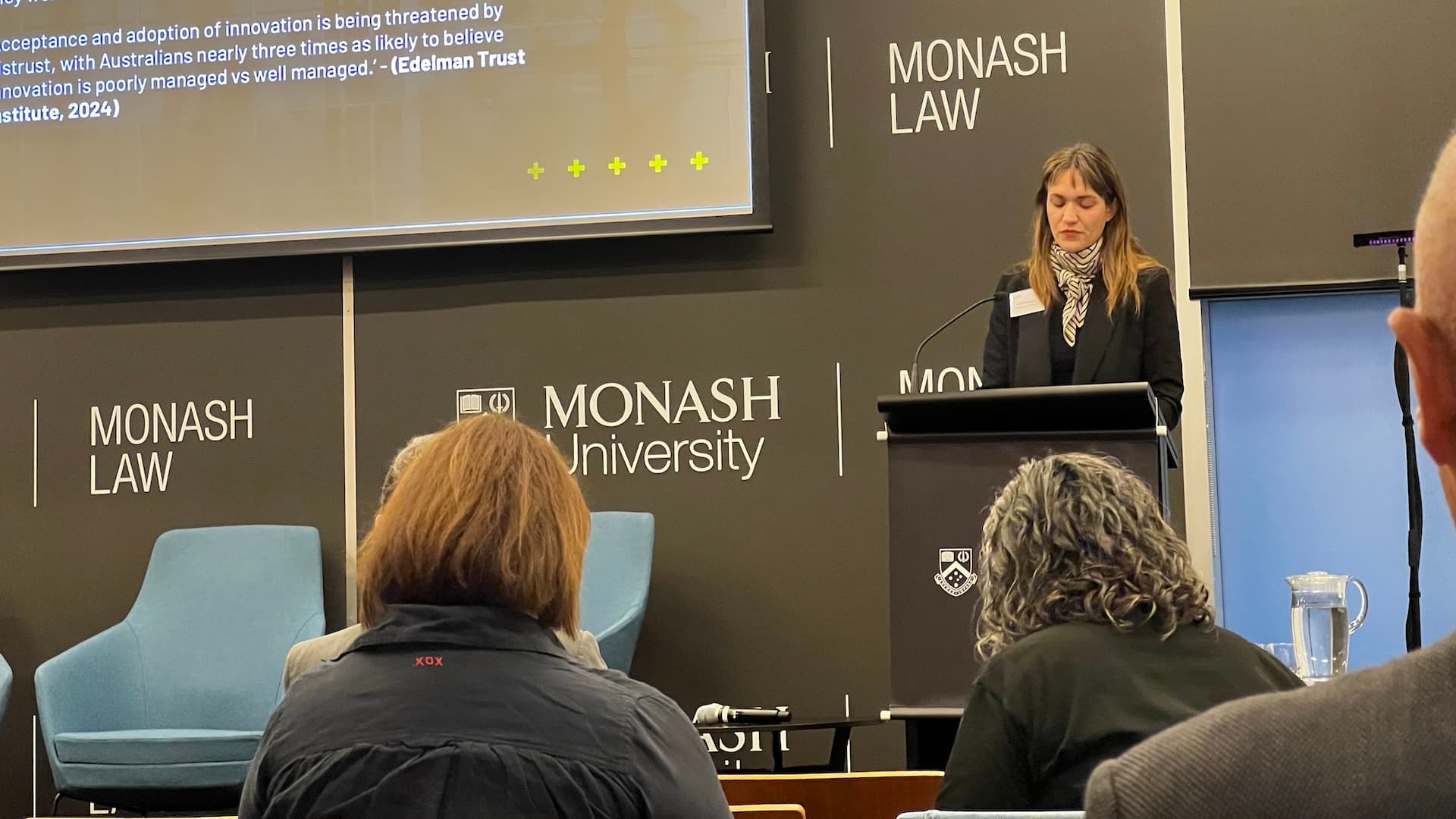Dr Lina Przhedetsky presenting at a lectern