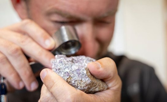scientist examining rock