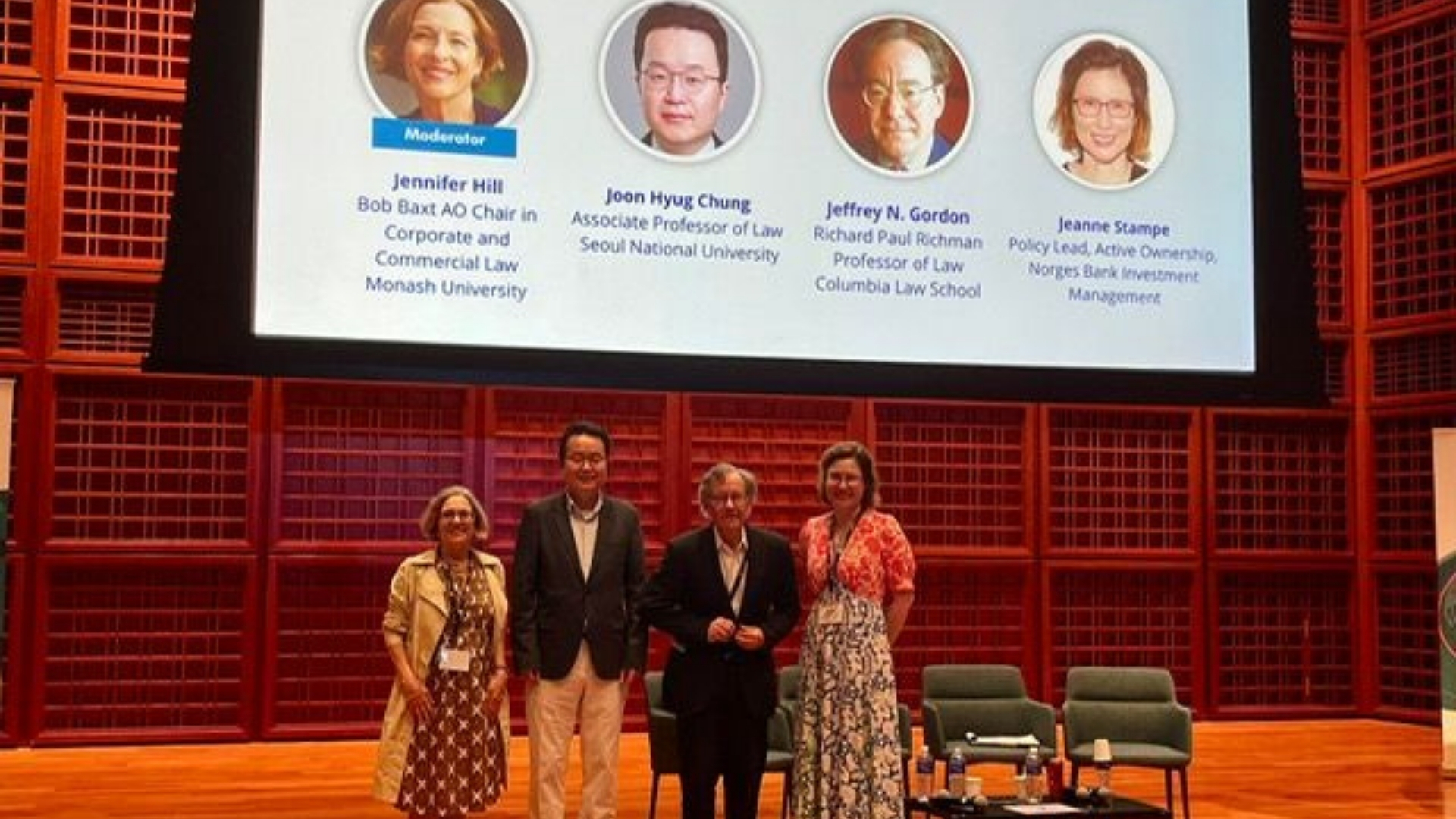 Photo of Professor Jennifer Hill and colleagues on stage for The Global Rebalancing of Corporate Governance Norms