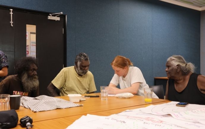 A photo of Nell Reidy engaging with Indigenous leaders at Galiwin'ku