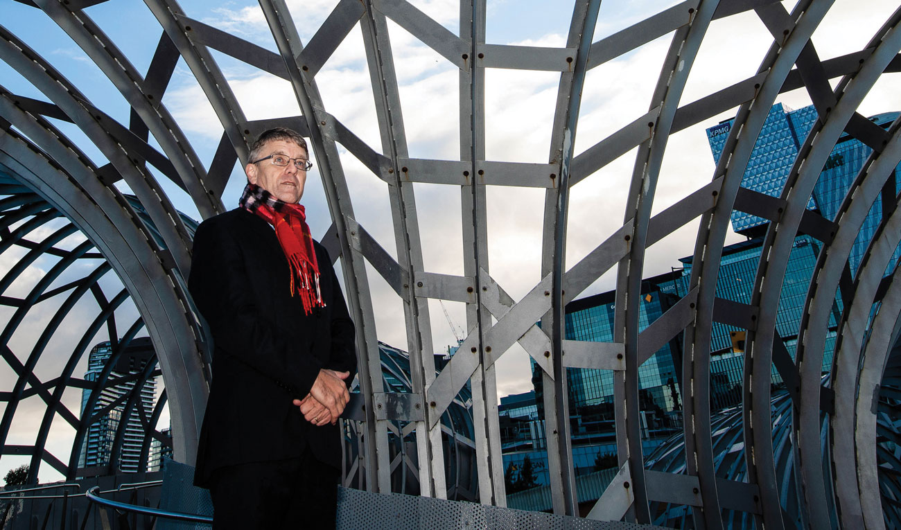 Graham Hawke standing in front of metal architectural frame