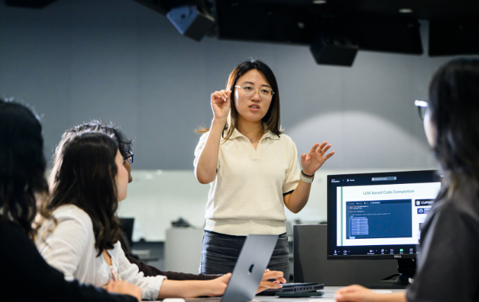 Student presenting during team meeting