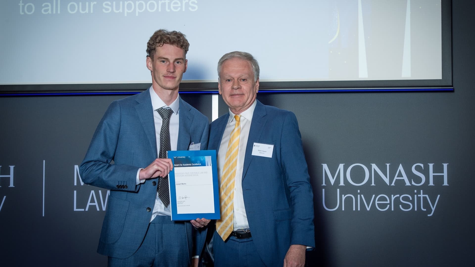 Joseph Martin accepts his prize from Mark Hayes of Maddocks.