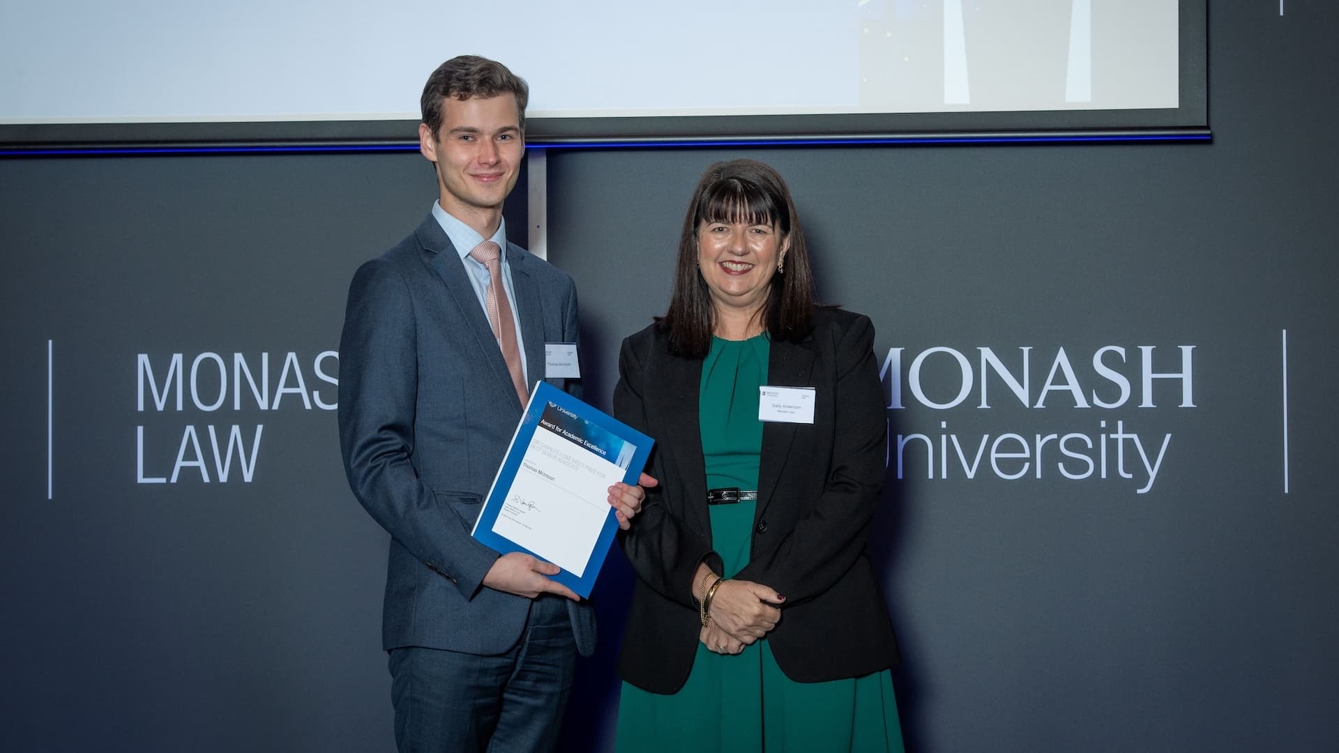 Thomas McIntosh accepts his prize from Sally Andersen, Experiential Education Lecturer.