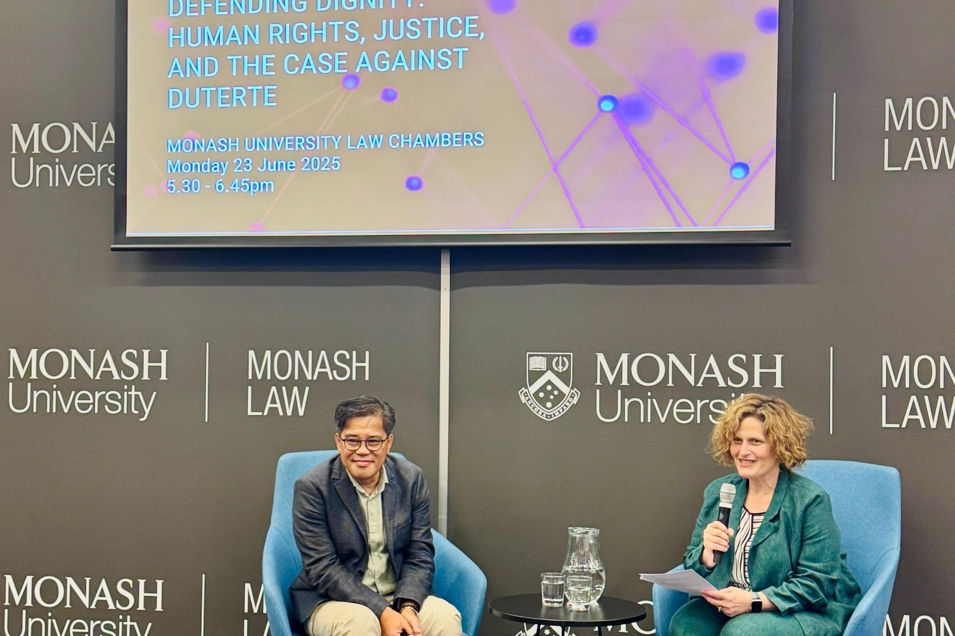 Carlos H. Conde and Sara Kowal in conversation on stage.