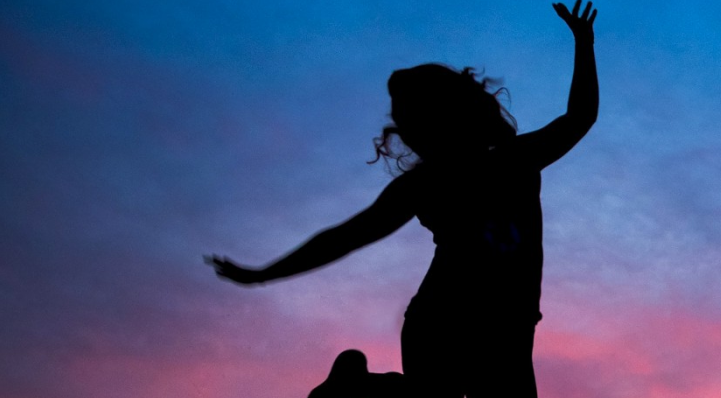 girl jumping in sunset banner