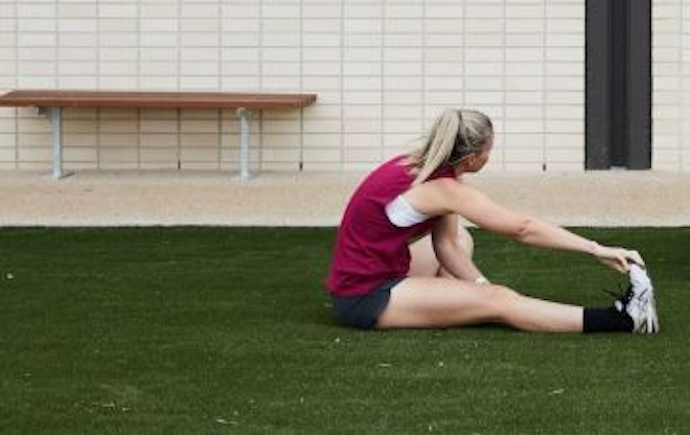 Woman stretching on grass