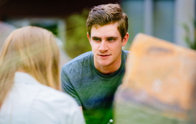 Man looking at friend who is out of focus