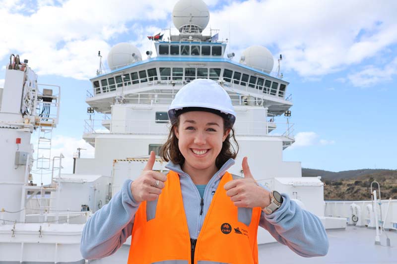 Amelia Pearson holding two thumbs up on the RV Investigator