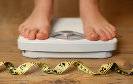 child's feet on weigh scales