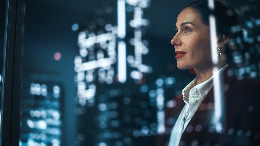 Businesswoman looking out of a window at an urban landscape