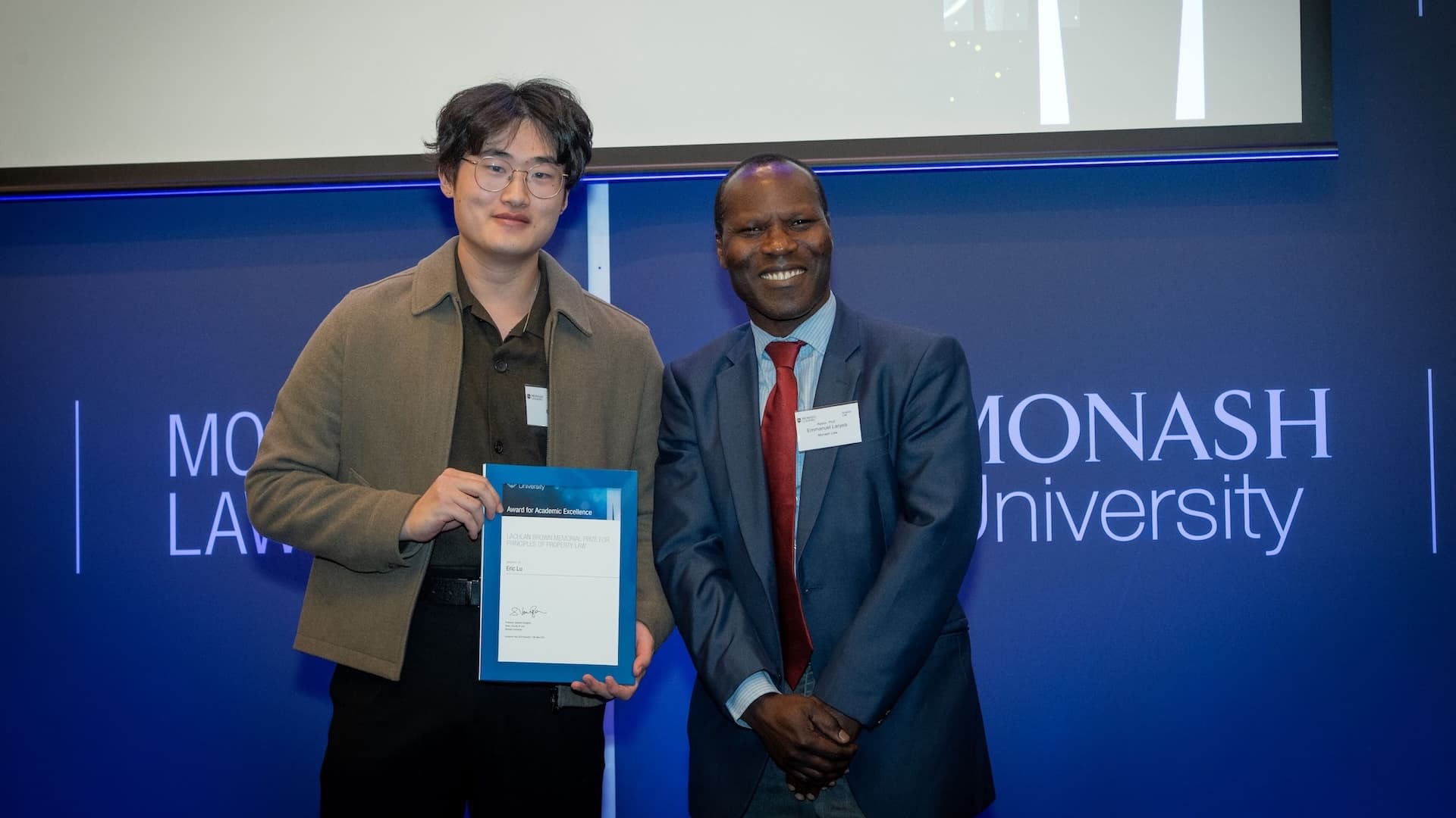 Eric Lu accepts his prize from Associate Professor Emmanuel Laryea.