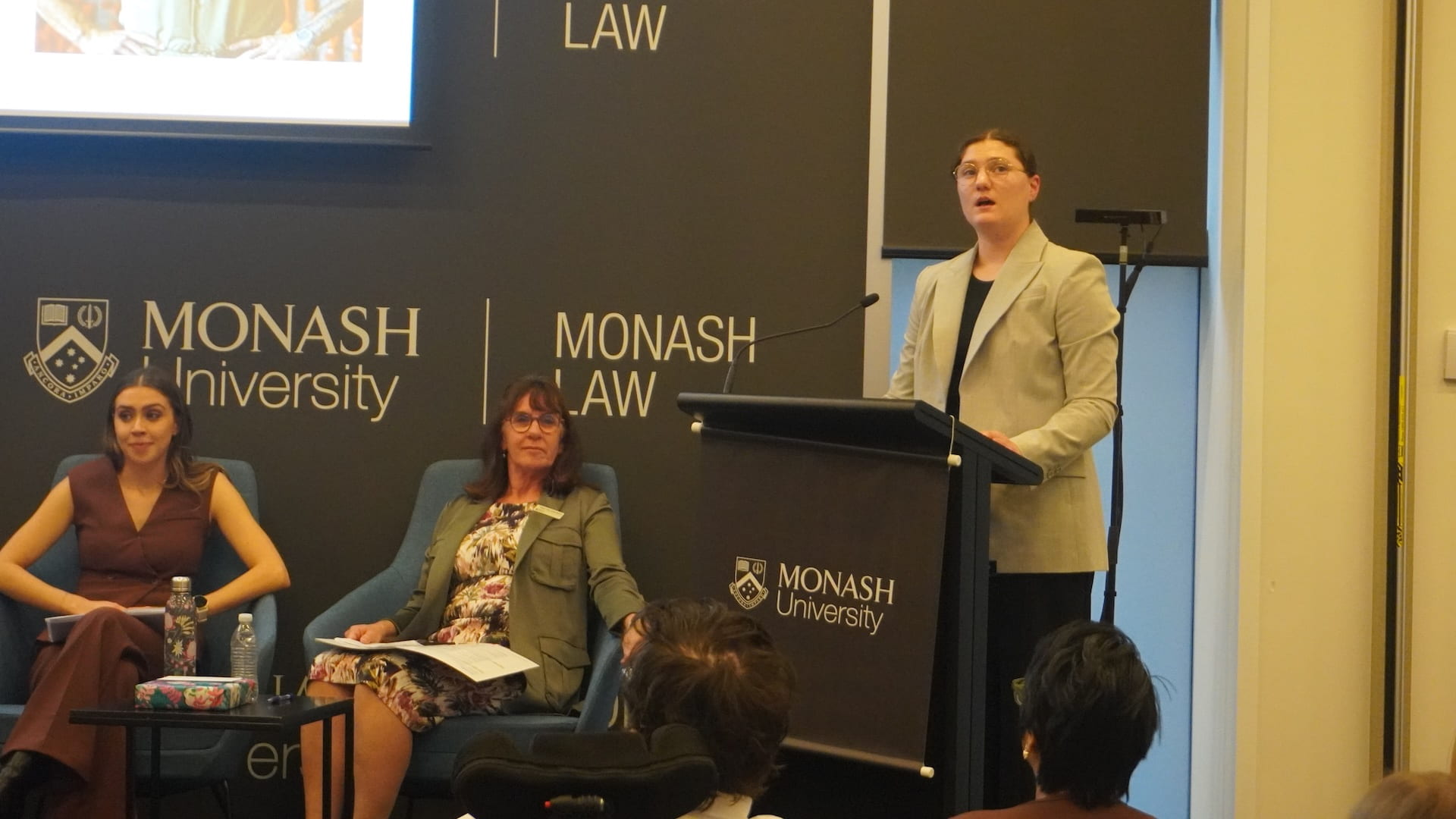 Emma Jelavic speaking at a lectern