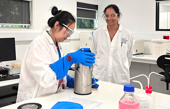 Heidi, Research Compliance Officer (blue gloves) at the mitoHOPE Program, and Tegan, mitoHOPE’s clinical embryologist, at work in the mitoHOPE laboratory at Monash University.