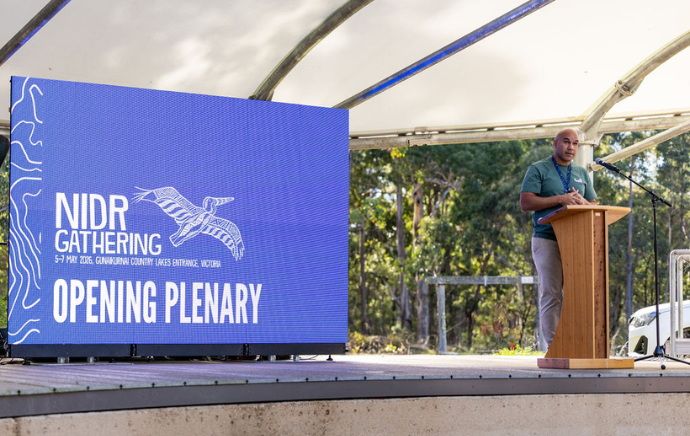Bhiamie Williamson giving the opening address at NIDR Gathering 2026 - credit Gabrielle Connole