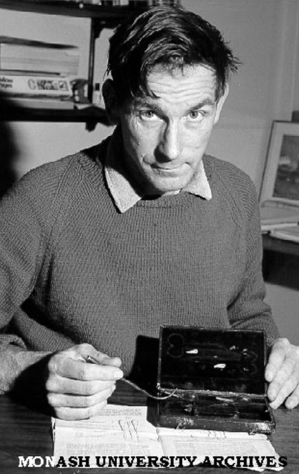 Professor John Michael Cullen examining egg-sucking kit 1979, Monash University Archives.