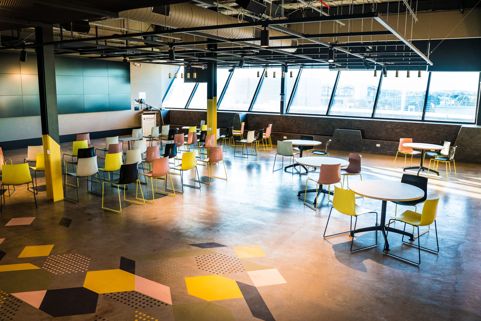 Green Chemicals Futures Empty multipurpose space with scattered chairs and tables