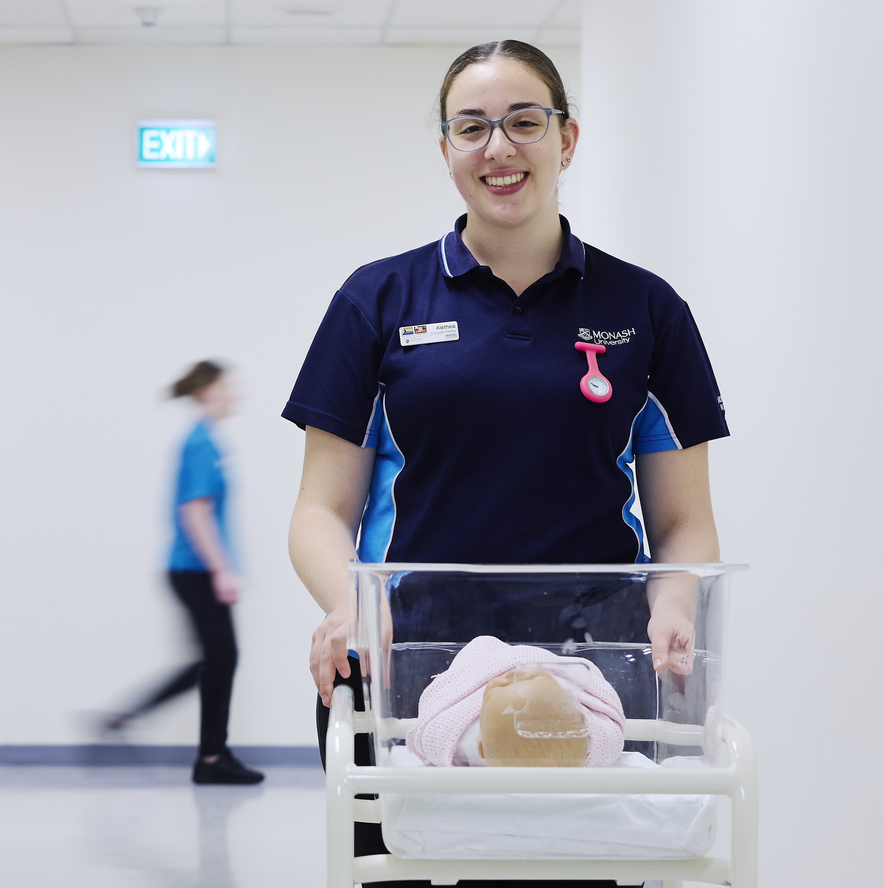 Alethea, Nursing and midwifery student in corridor with crib 