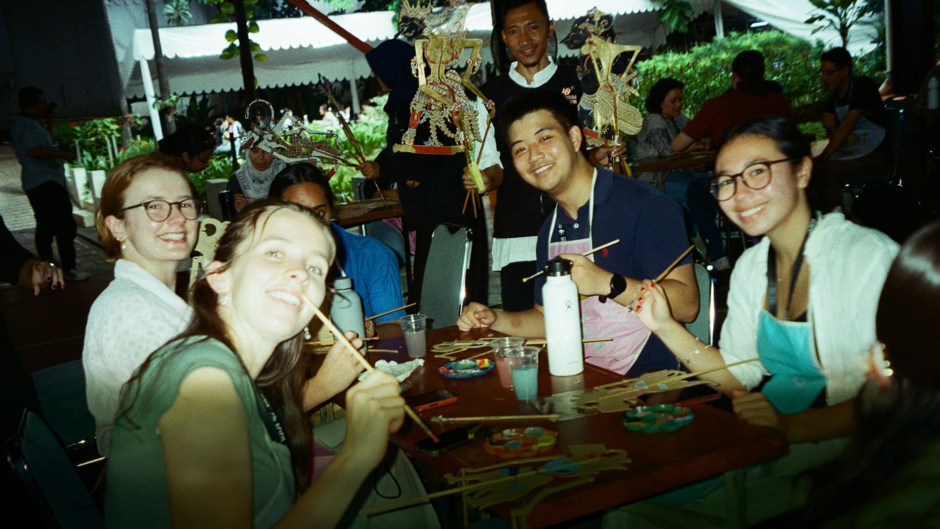 Painting wayang puppets, as part of the cultural immersion at Atma Jaya University