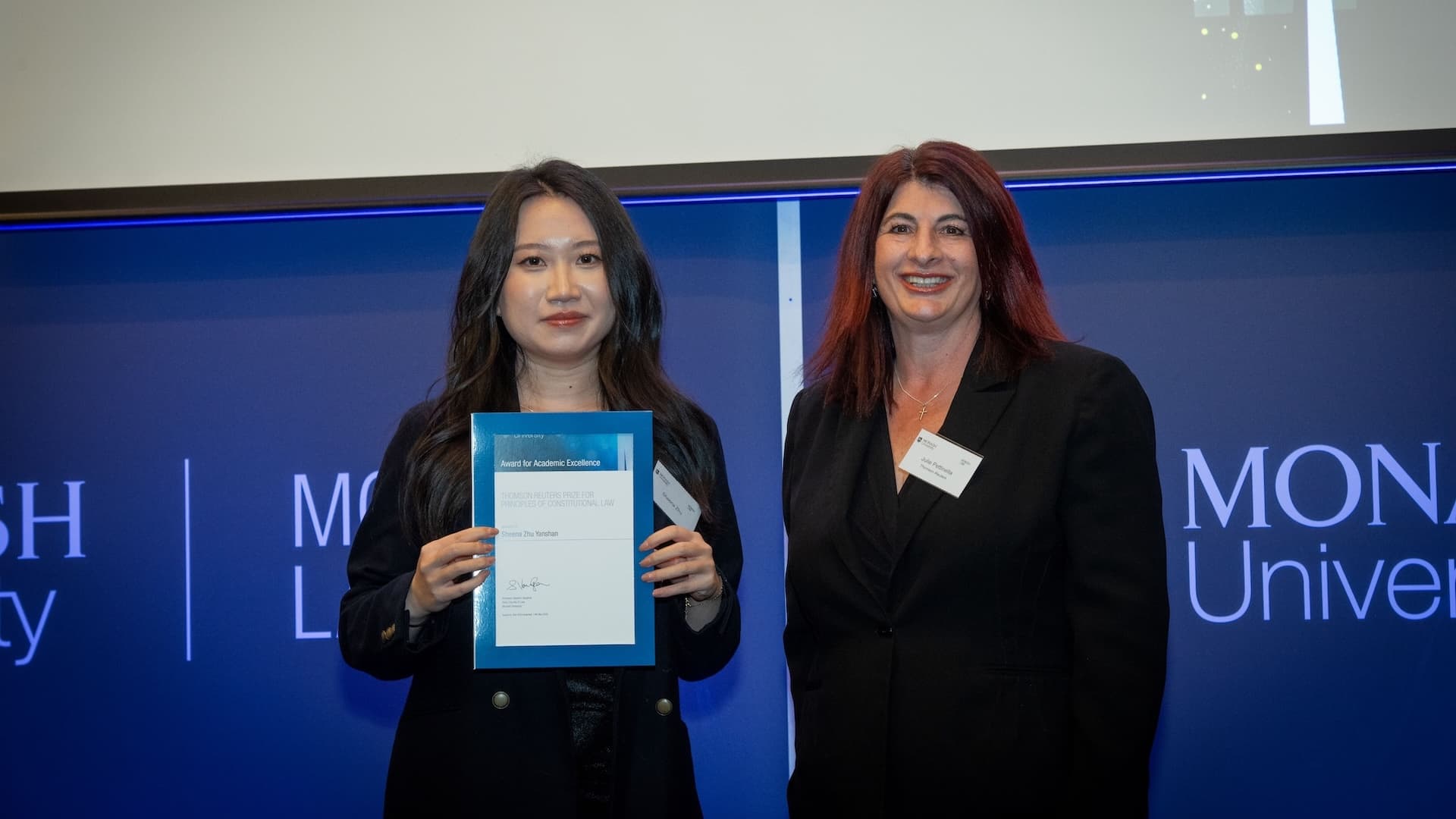 Sheena Zhu Yanshan accepts her prize from Julie Petinella of Thomson Reuters.