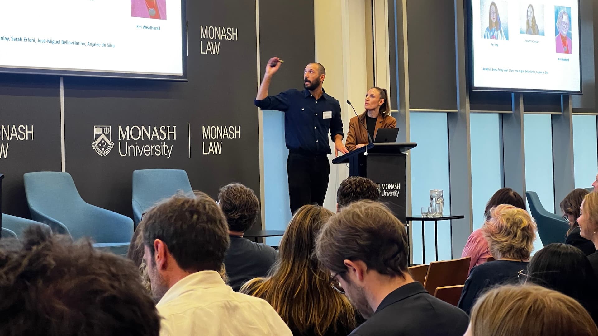 Dr Jake Goldenfein and Alexandra Sinclair presenting at a lectern