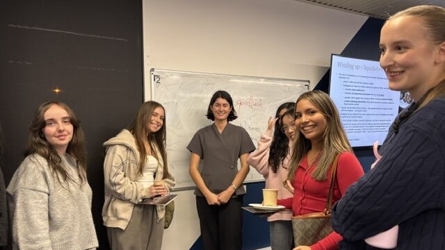 Monash Law alumna and ABL lawyer, Lulu Morton, surrounded by Monash Law students.