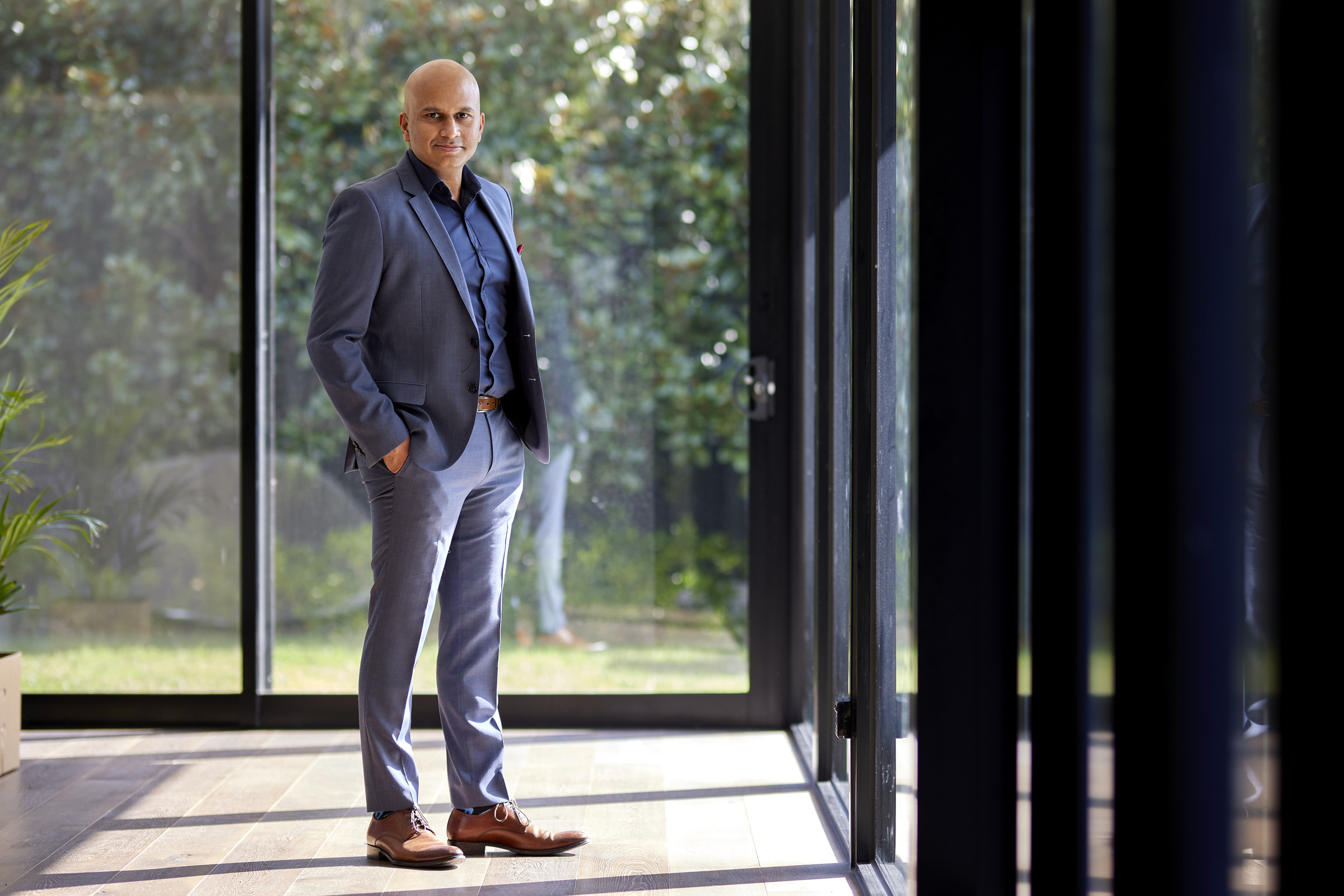 Head-to-toe image of alumni in a suit