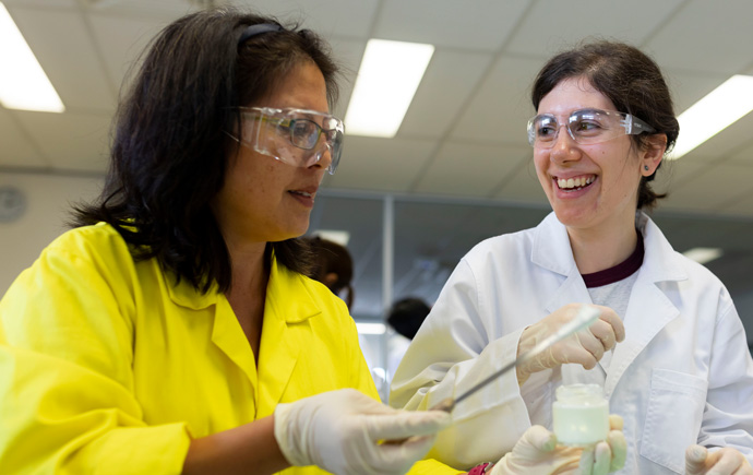 A Monash Pharmacy teacher helping a student with a lab experiment.