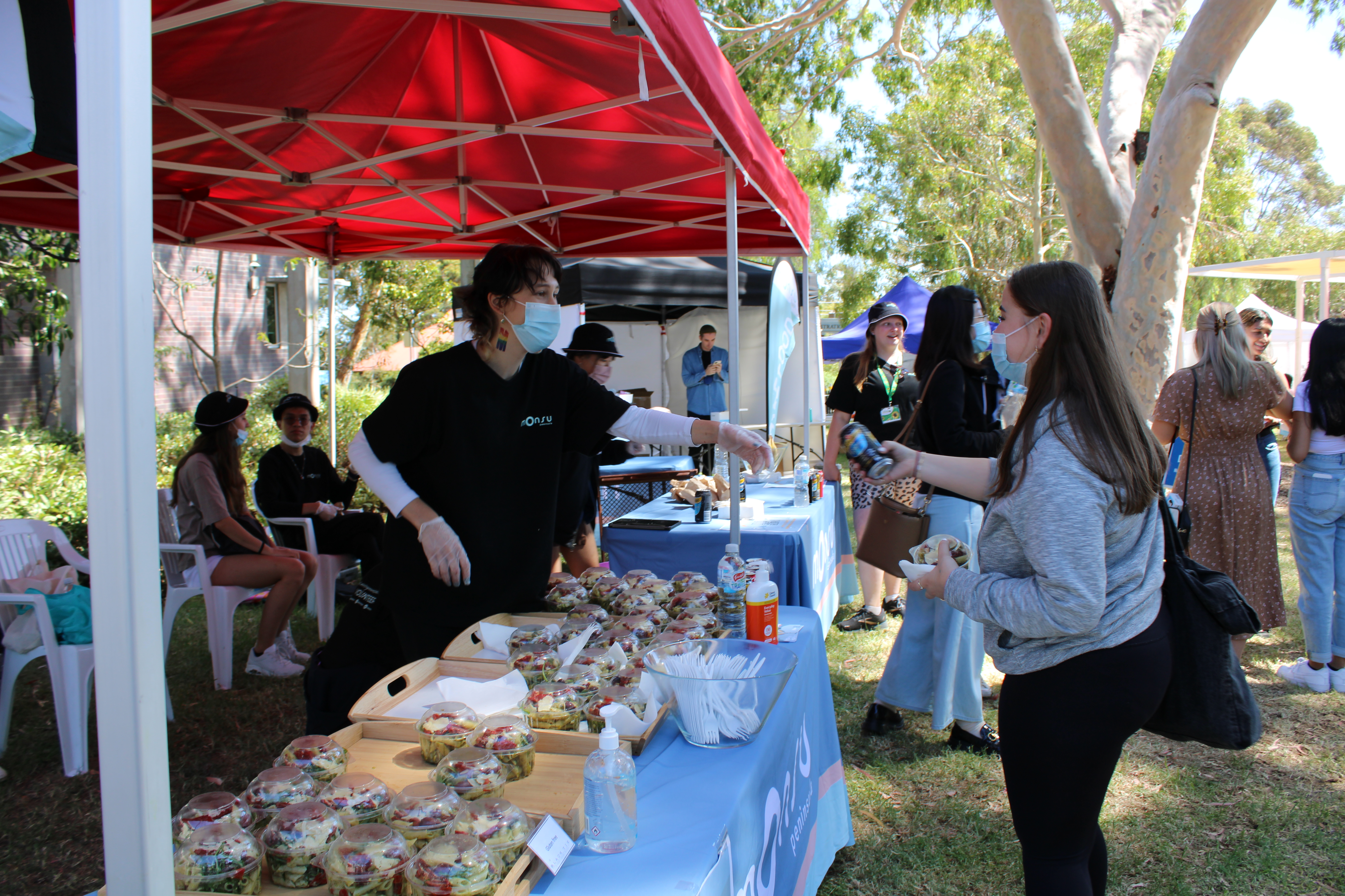 staff going to a market stall to get food